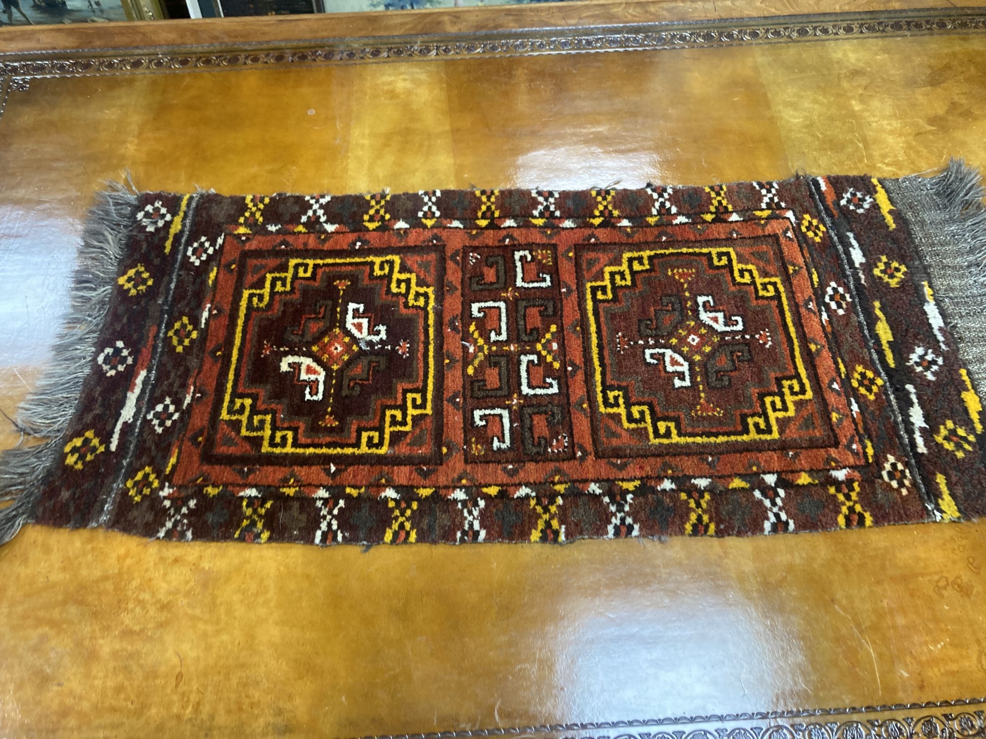 Six Caucasian design mats and a saddlebag, largest 140 x 60cm